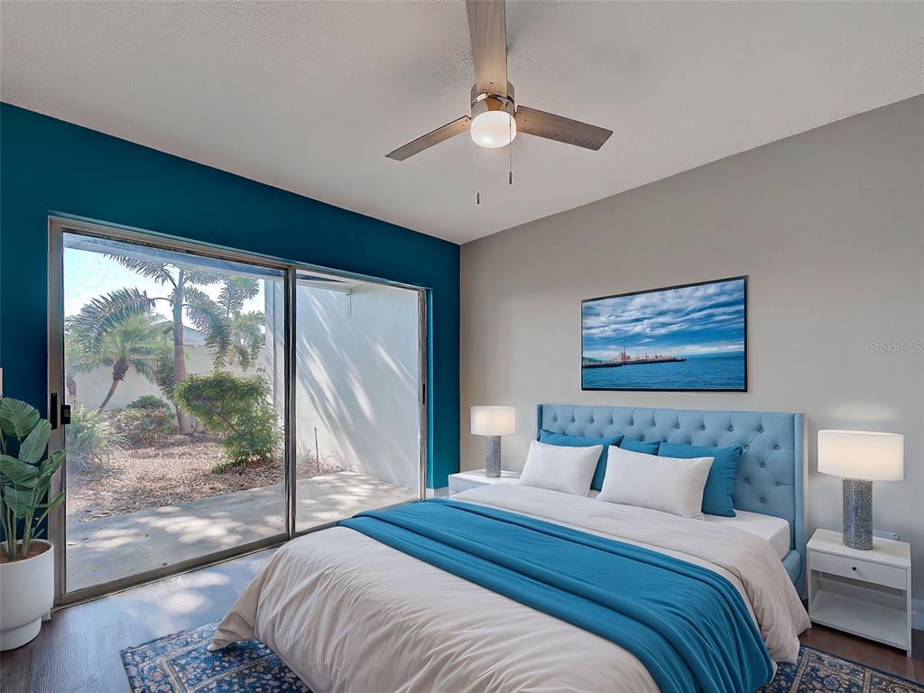 429 Cerromar Lane, Unit 352 Venice, FL 34293 - Photo 32 of 47 a bedroom with a large bed and a large window