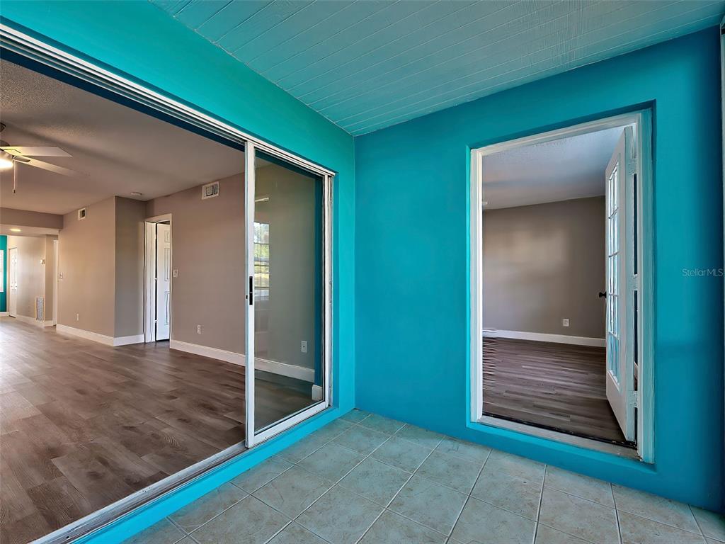 429 Cerromar Lane, Unit 352 Venice, FL 34293 - Photo 34 of 47 a view of a hallway with wooden floor and a kitchen