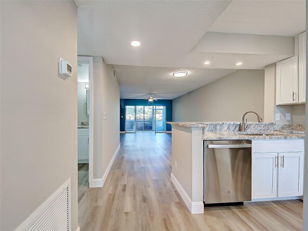 429 Cerromar Lane, Unit 352 Venice, FL 34293 - Photo 5 of 47 a kitchen with a sink and wooden cabinets