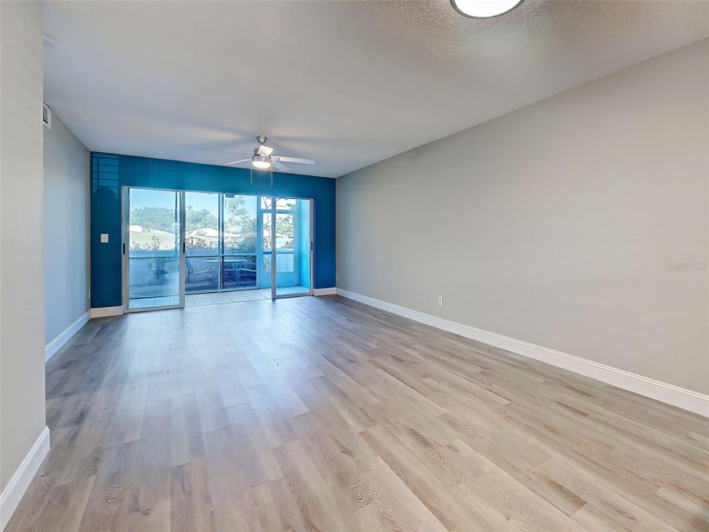 429 Cerromar Lane, Unit 352 Venice, FL 34293 - Photo 6 of 47 wooden floor in an empty room with a window