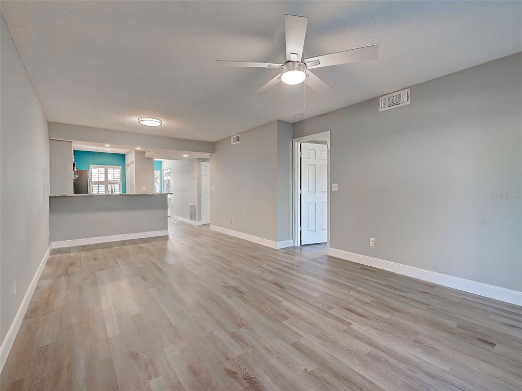 429 Cerromar Lane, Unit 352 Venice, FL 34293 - Photo 7 of 47 a view of wooden floor and windows in a room