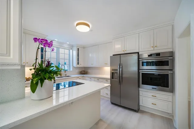 a kitchen with a refrigerator and a sink