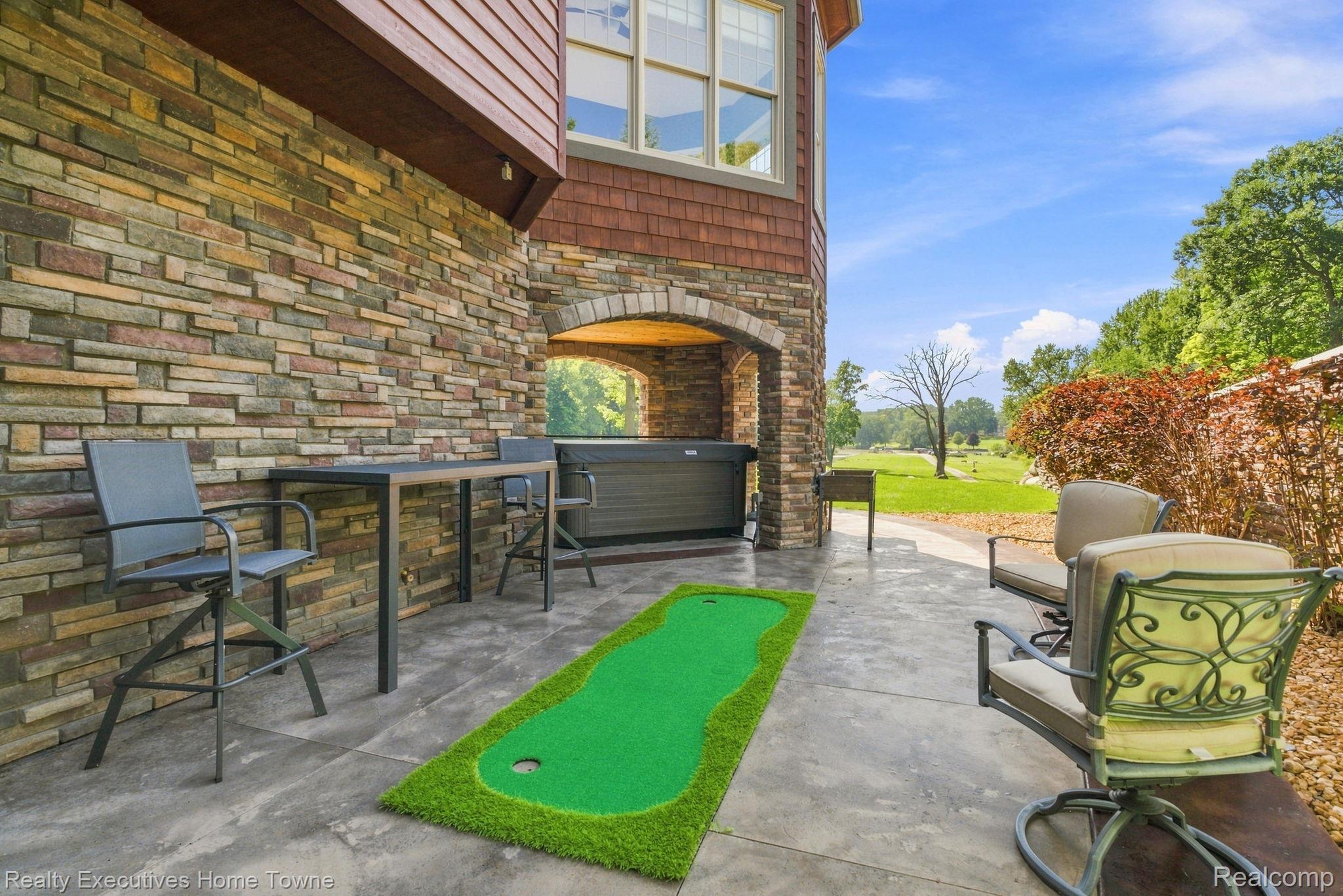 2829 Riverside Drive Port Huron, MI 48060 - Photo 72 of 99 Stone veneer exterior with shake siding accents, covered patio area, and an integrated hot tub space