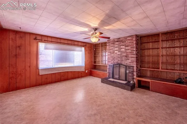 wooden floor in an empty room with a fireplace