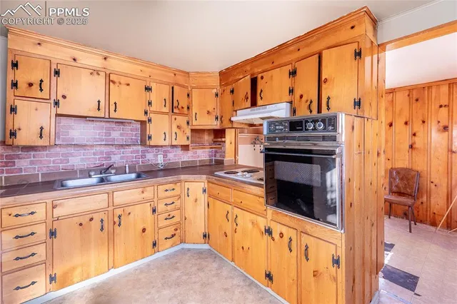 a kitchen with stainless steel appliances granite countertop a stove and a sink
