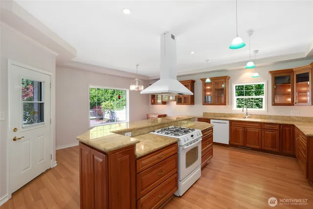 a kitchen with a stove a sink a refrigerator and window