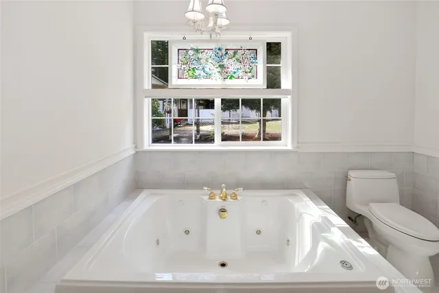 a bathroom with a bathtub and window