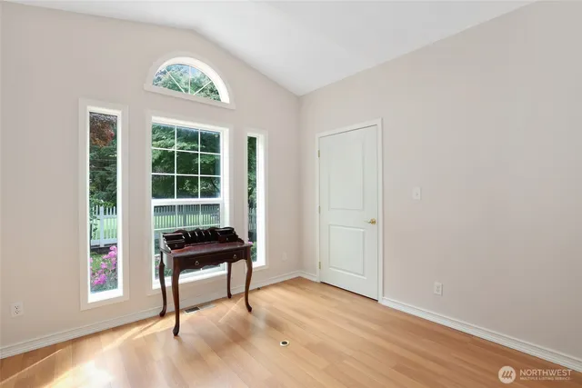 a view of a workspace with furniture and a window