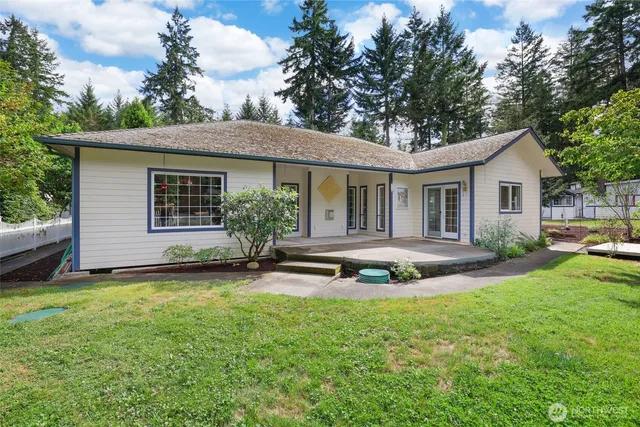 a view of a house with a yard and sitting area