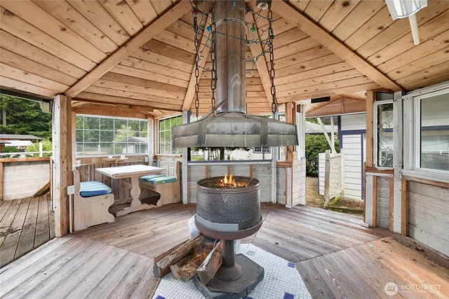 a view of a chairs and table in patio with a barbeque
