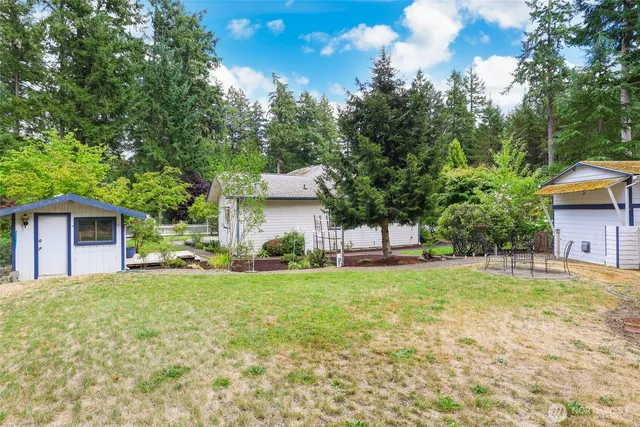 a view of a house with a yard and sitting area
