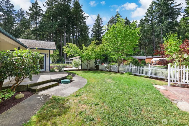 a view of a backyard with swimming pool