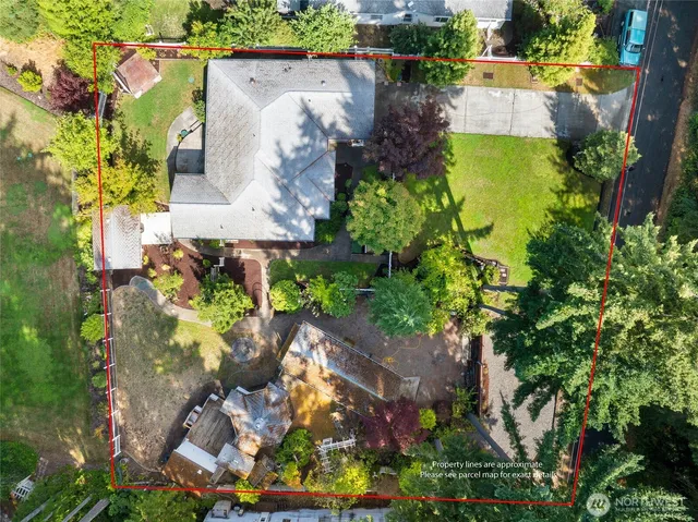 an aerial view of a house with a yard and garden