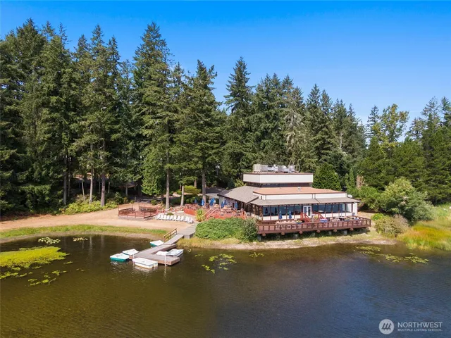 a tall yellow building with trees in the background