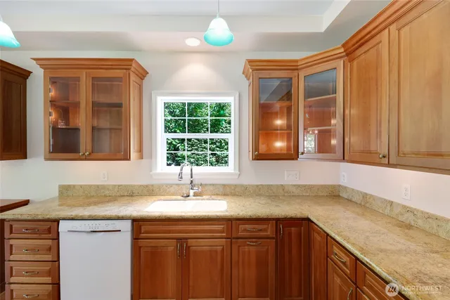 a kitchen with a sink cabinets and window