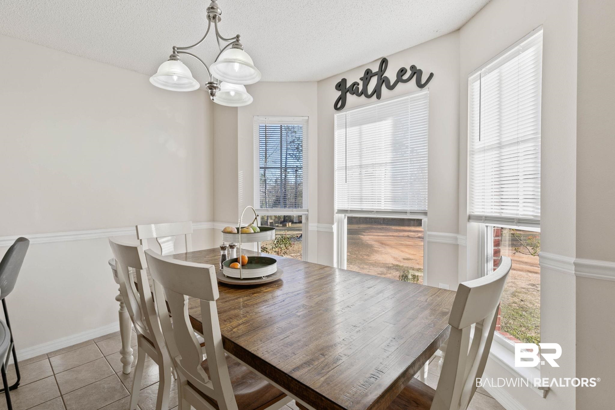 55750 Lottie Road Perdido, AL 36562 - Photo 61 of 84 Dining room featuring hanging lights, light tile patterned floors, and a textured ceiling