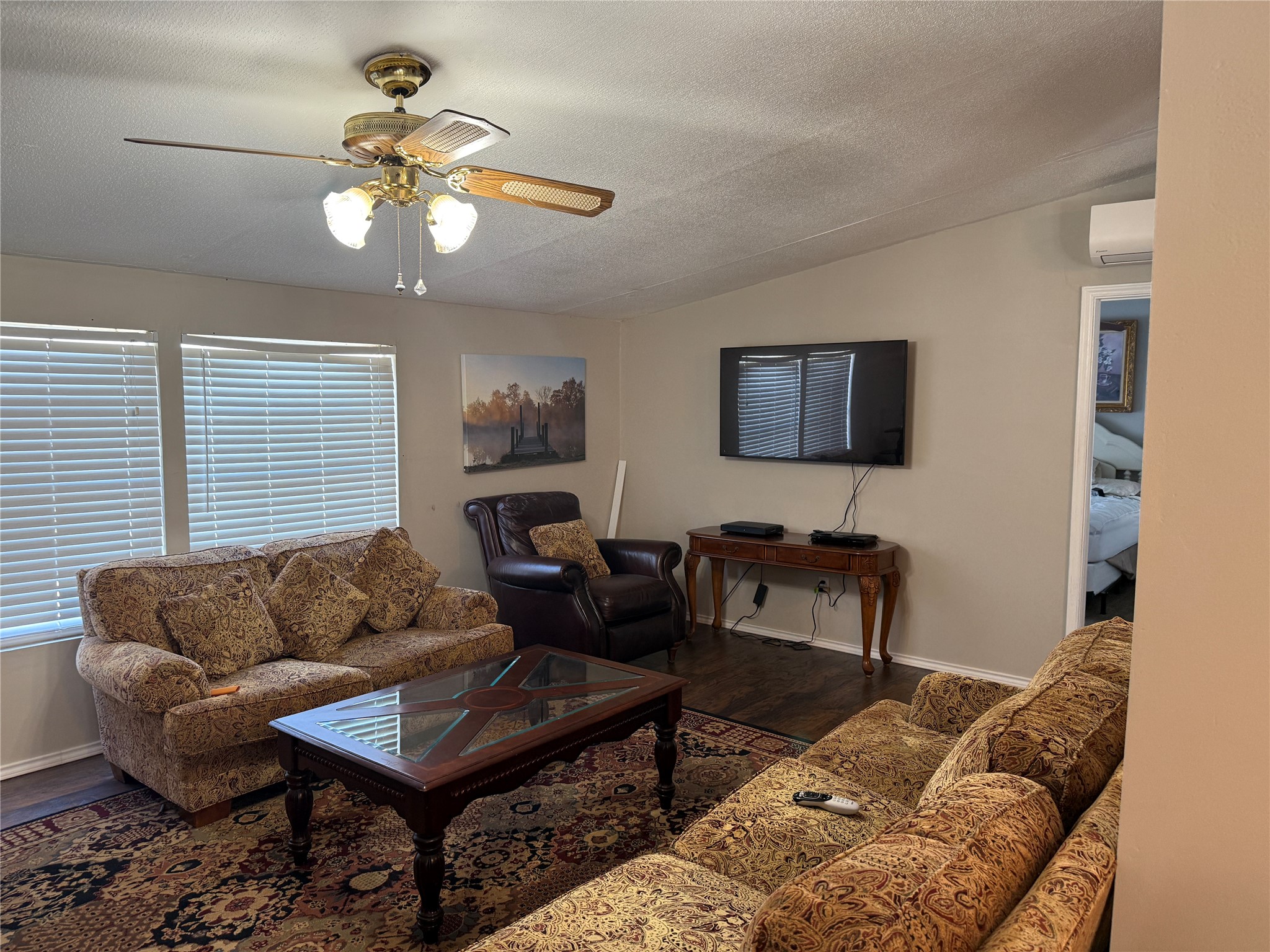 7538 Rocky Ridge Lane Madisonville, TX 77864 - Photo 12 of 48 a living room with furniture a dining table and a flat screen tv