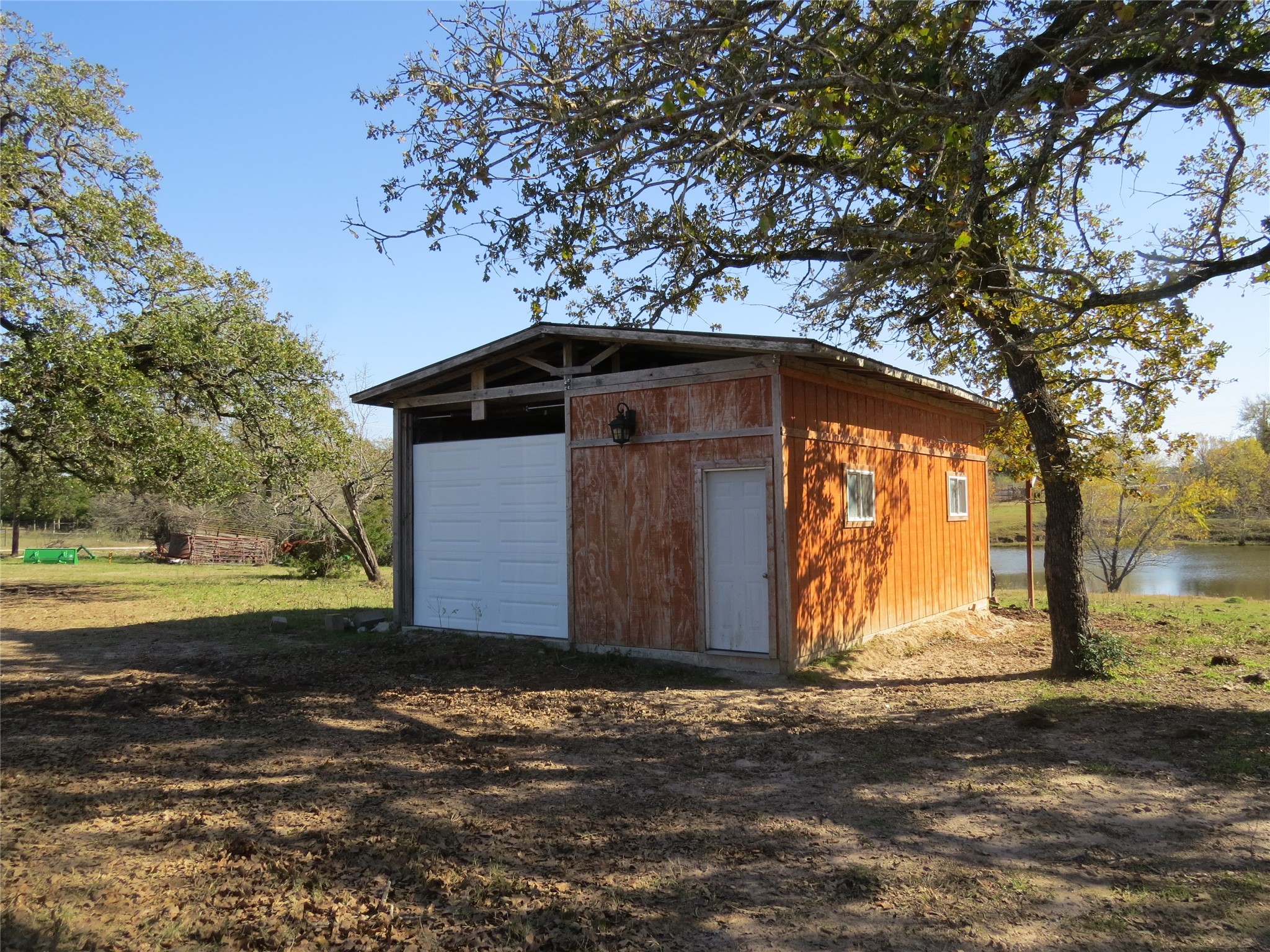 7538 Rocky Ridge Lane Madisonville, TX 77864 - Photo 43 of 47 Spacious garage with rustic charm, nestled in a serene setting by the water—ideal for storage or a workshop.