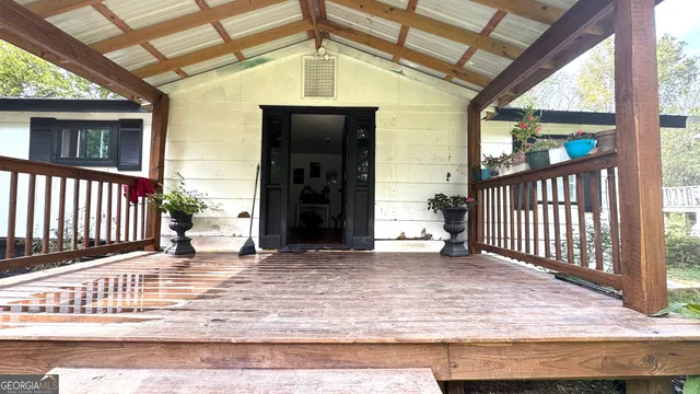 a view of a porch with a table and chairs
