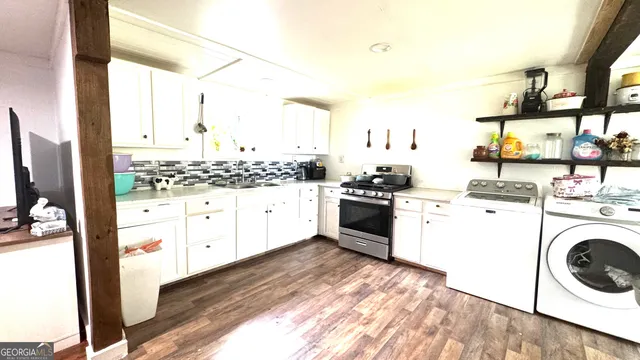 a kitchen with a stove a sink and a refrigerator
