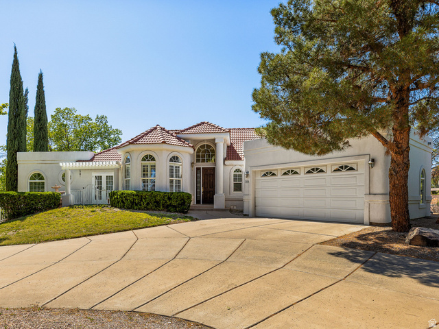 389 North Main Street St. George, UT 84770 - Photo 1 of 44 Mediterranean / spanish-style house featuring driveway, stucco siding, and an attached garage
