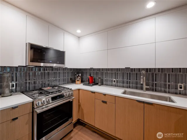 a kitchen with stainless steel appliances a refrigerator and a stove top oven