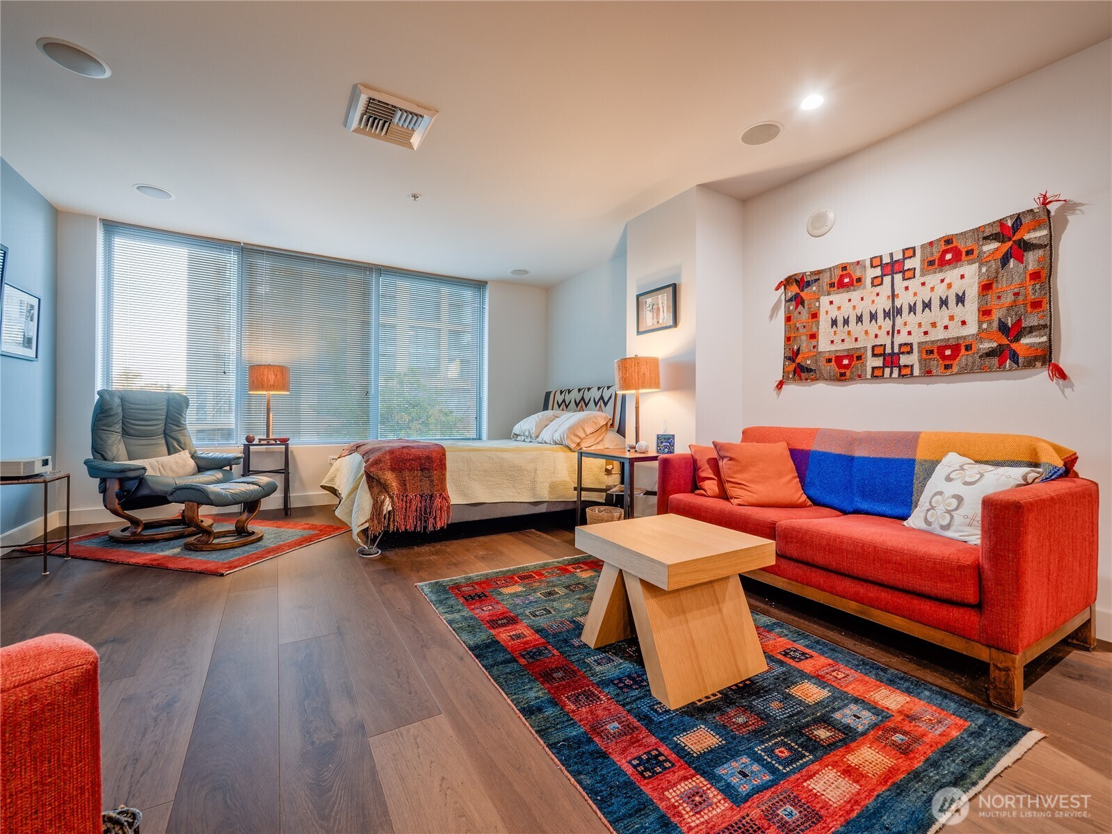 910 Lenora Street, Unit 200 Seattle, WA 98121 - Photo 5 of 23 a bedroom with furniture and a wooden floor