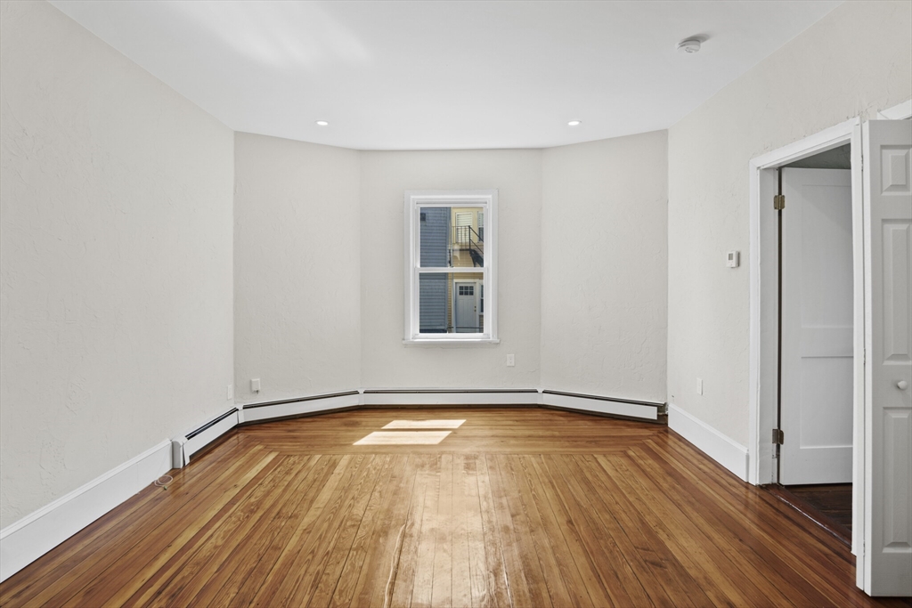 10 Redfield Street, Unit 2 Boston, MA 02122 - Photo 6 of 10 a view of empty room with wooden floor