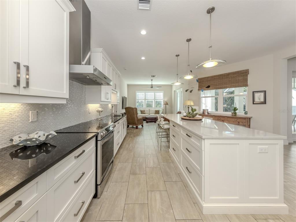 332 Pensacola Road Venice, FL 34285 - Photo 15 of 56 a large kitchen with stainless steel appliances lots of counter space and wooden floor