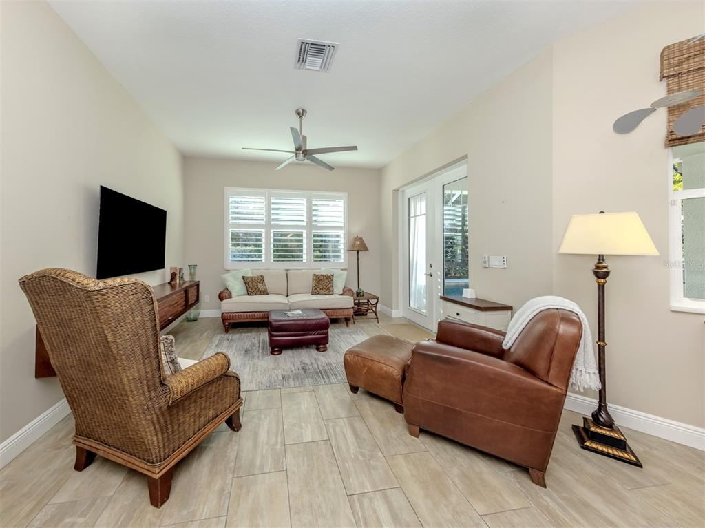 332 Pensacola Road Venice, FL 34285 - Photo 16 of 56 a living room with furniture and a flat screen tv