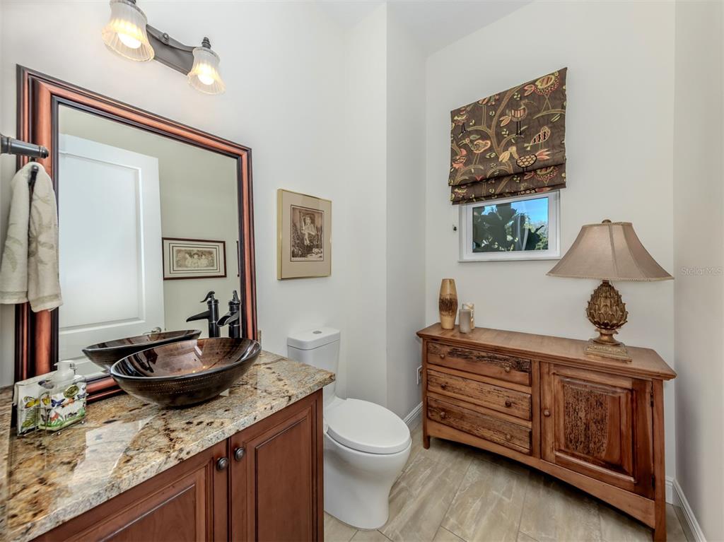 332 Pensacola Road Venice, FL 34285 - Photo 18 of 56 a living room with granite countertop furniture and a wooden floor