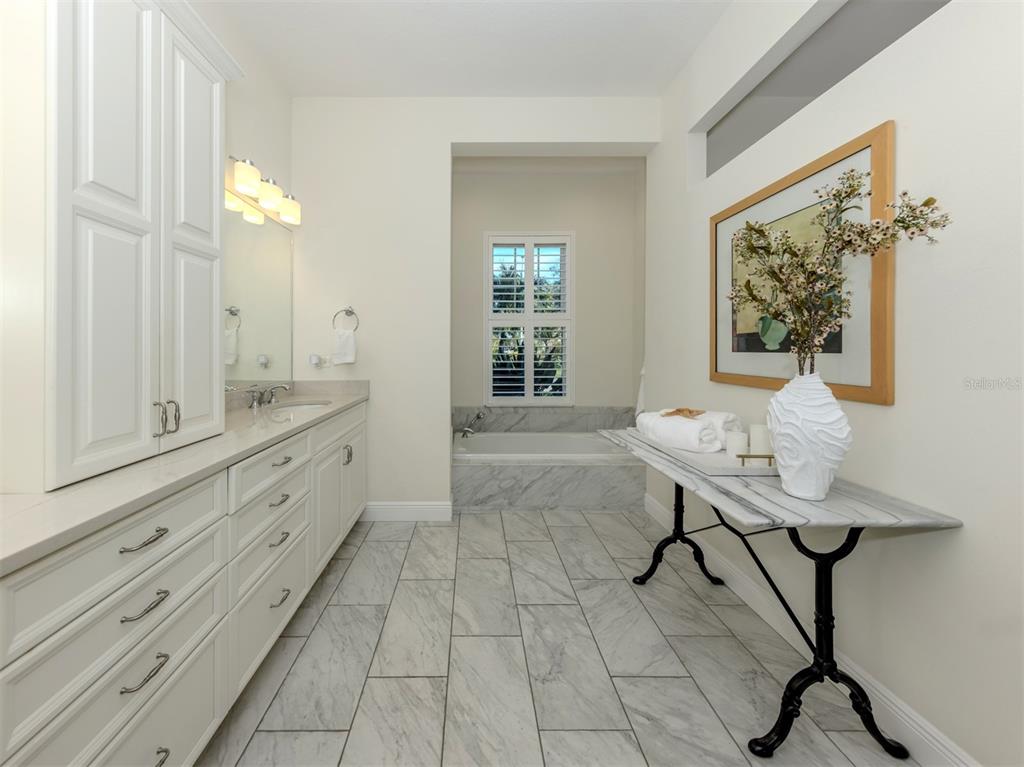 332 Pensacola Road Venice, FL 34285 - Photo 20 of 56 a spacious bathroom with a double vanity sink and a mirror