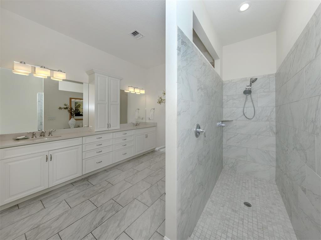 332 Pensacola Road Venice, FL 34285 - Photo 21 of 56 a bathroom with a granite countertop sink a mirror a shower and a mirror