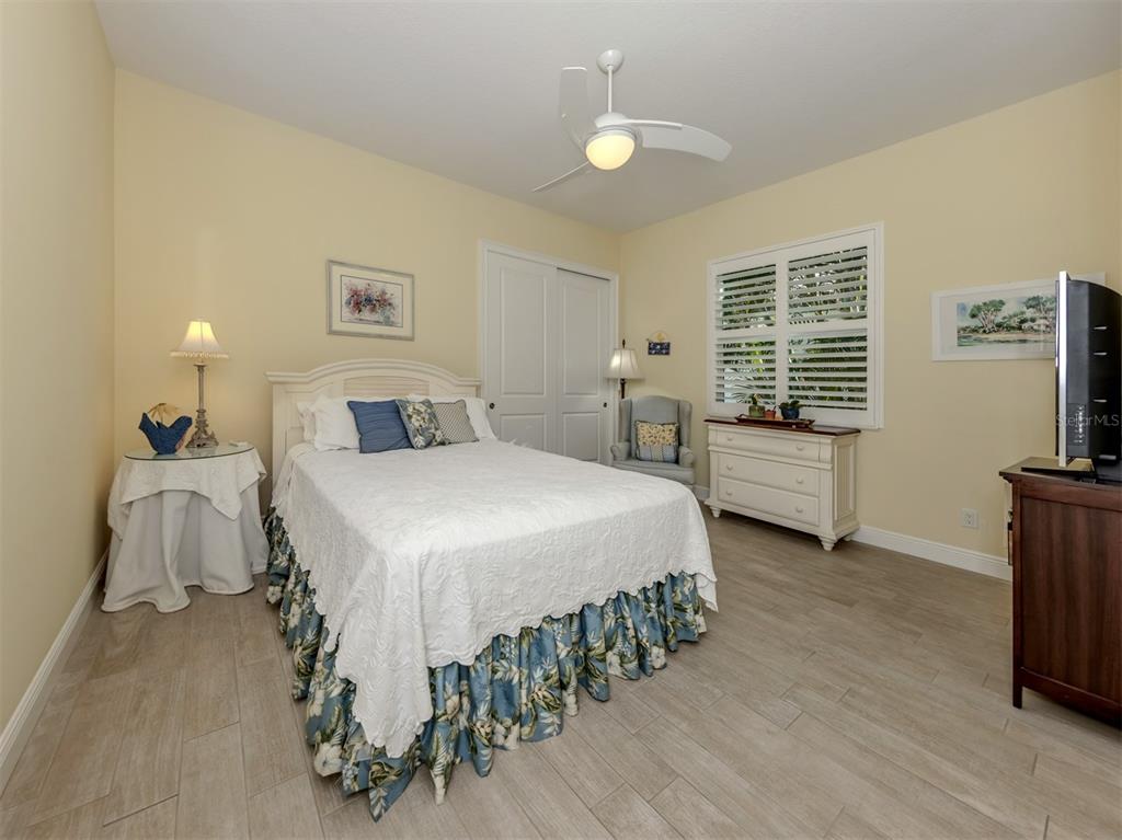 332 Pensacola Road Venice, FL 34285 - Photo 24 of 56 a bedroom with a bed and a chandelier