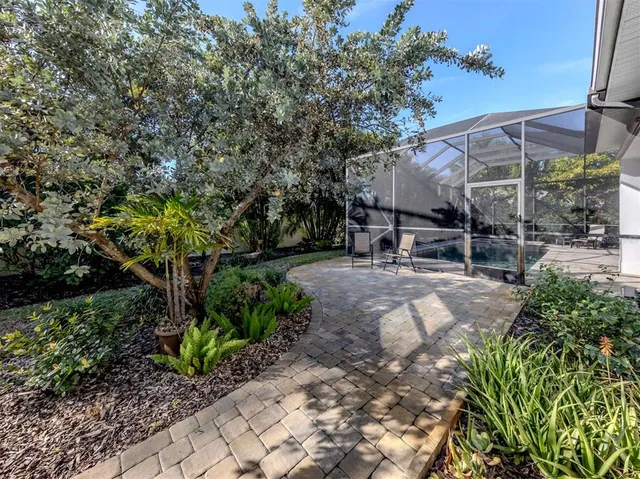 a view of patio with table and chairs under an umbrella