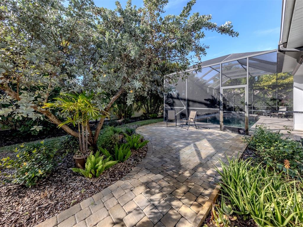 332 Pensacola Road Venice, FL 34285 - Photo 29 of 56 a view of patio with table and chairs under an umbrella