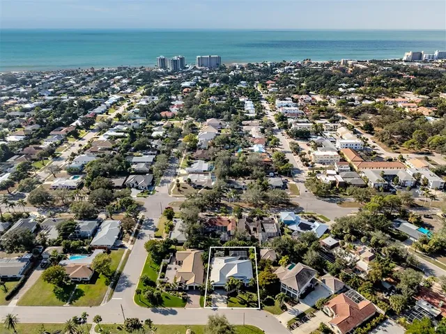 an aerial view of a house with a yard