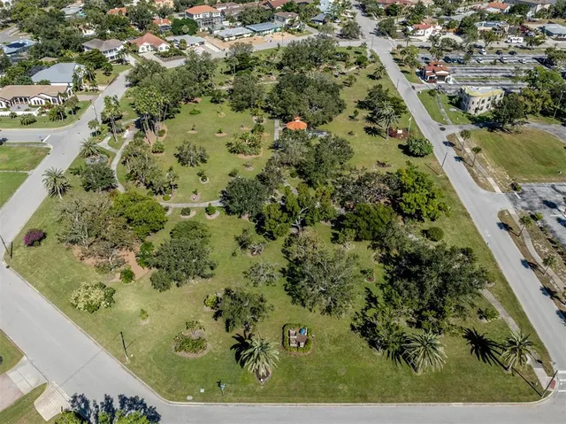 a view of a garden with a table and chairs under an umbrella