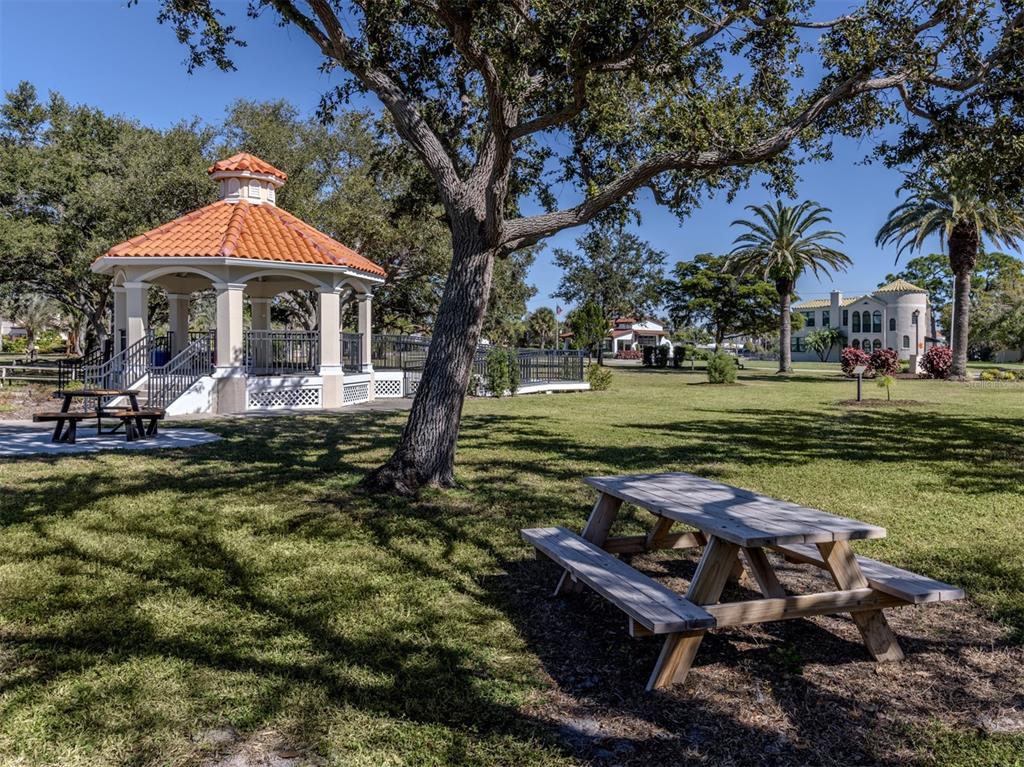 332 Pensacola Road Venice, FL 34285 - Photo 37 of 56 a view of a garden with a table and chairs under an umbrella