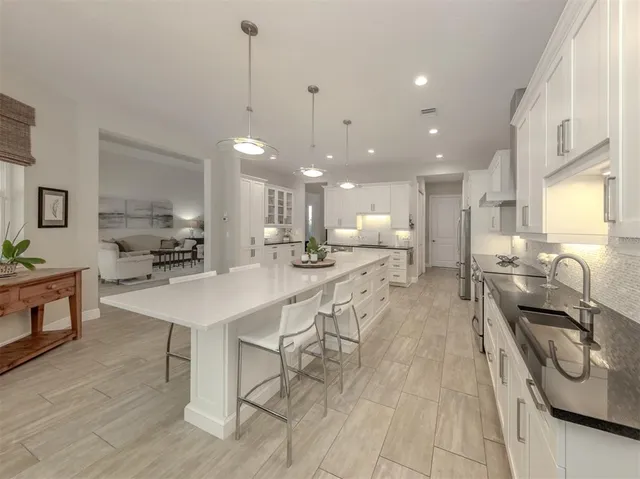 a kitchen with stainless steel appliances kitchen island granite countertop a sink and cabinets