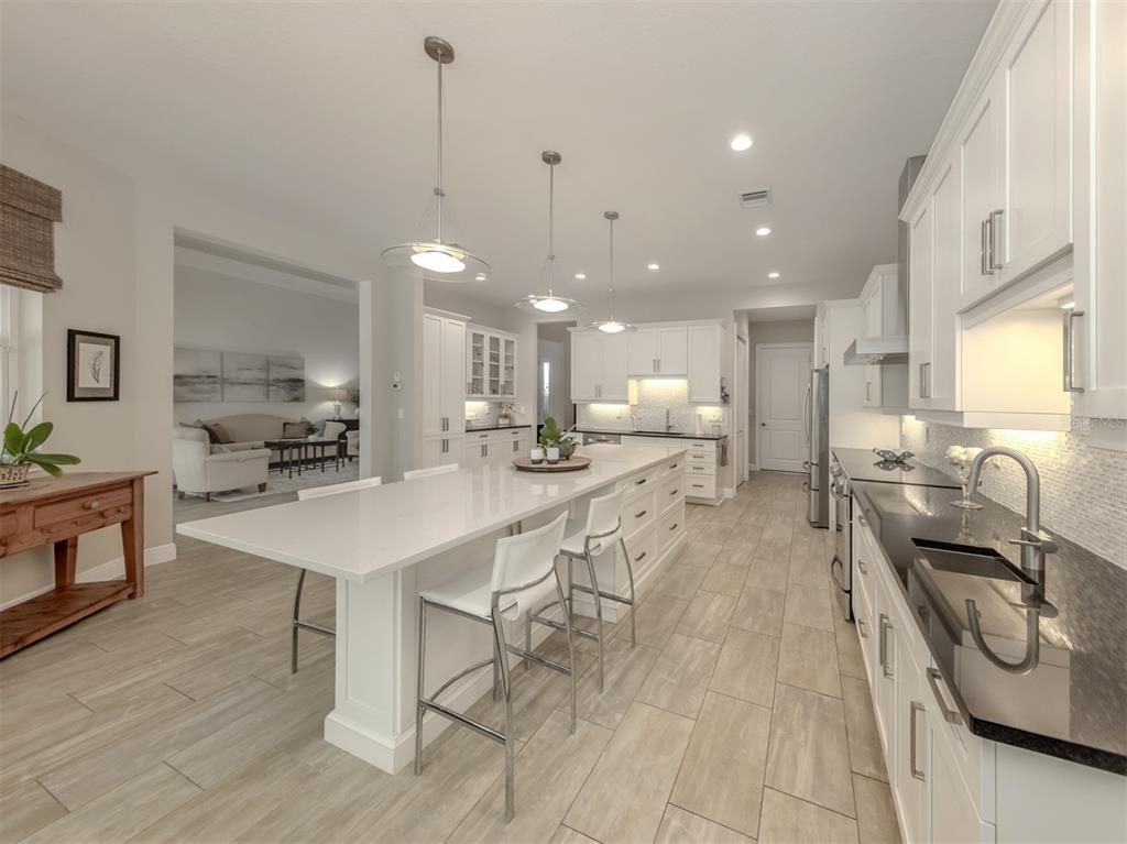 332 Pensacola Road Venice, FL 34285 - Photo 4 of 56 a kitchen with stainless steel appliances kitchen island granite countertop a sink and cabinets