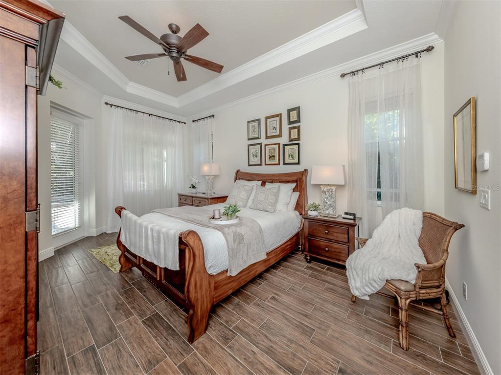 332 Pensacola Road Venice, FL 34285 - Photo 5 of 56 a bedroom with a bed and wooden floor