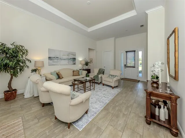 a living room with furniture and a potted plant