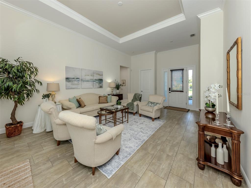 332 Pensacola Road Venice, FL 34285 - Photo 9 of 56 a living room with furniture and a potted plant