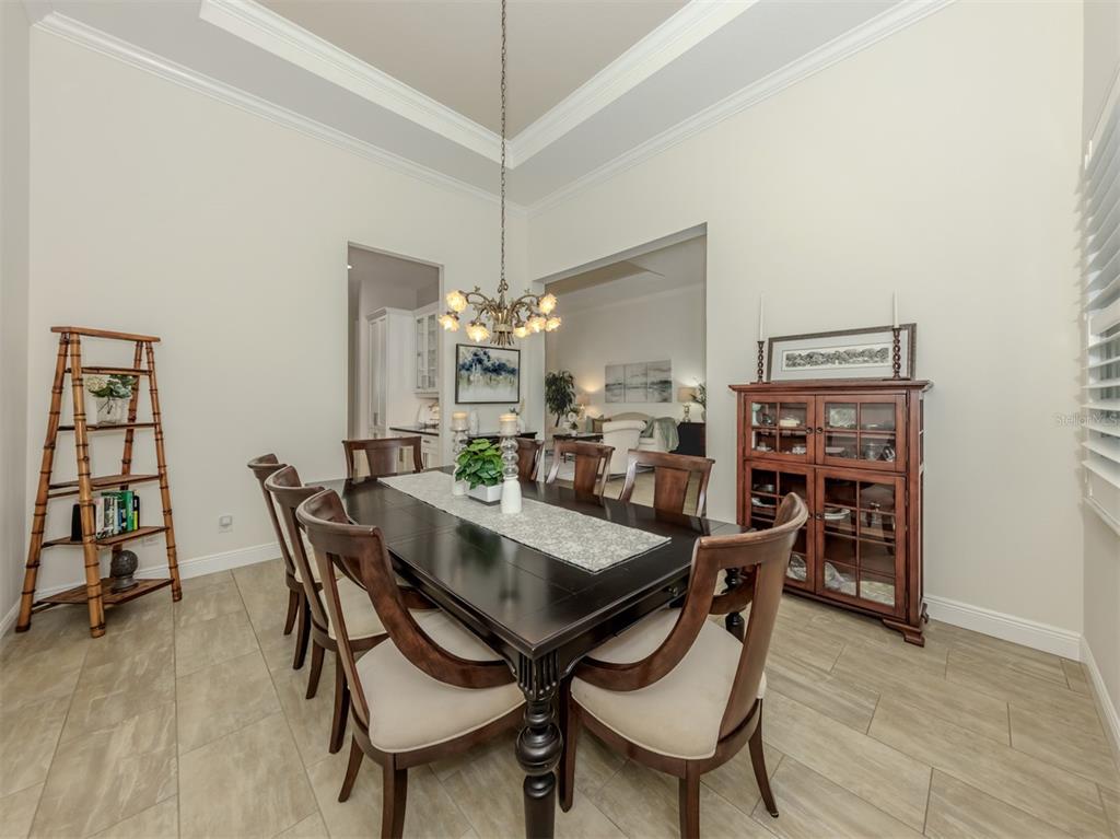 332 Pensacola Road Venice, FL 34285 - Photo 10 of 56 a view of a dining room with furniture and wooden floor