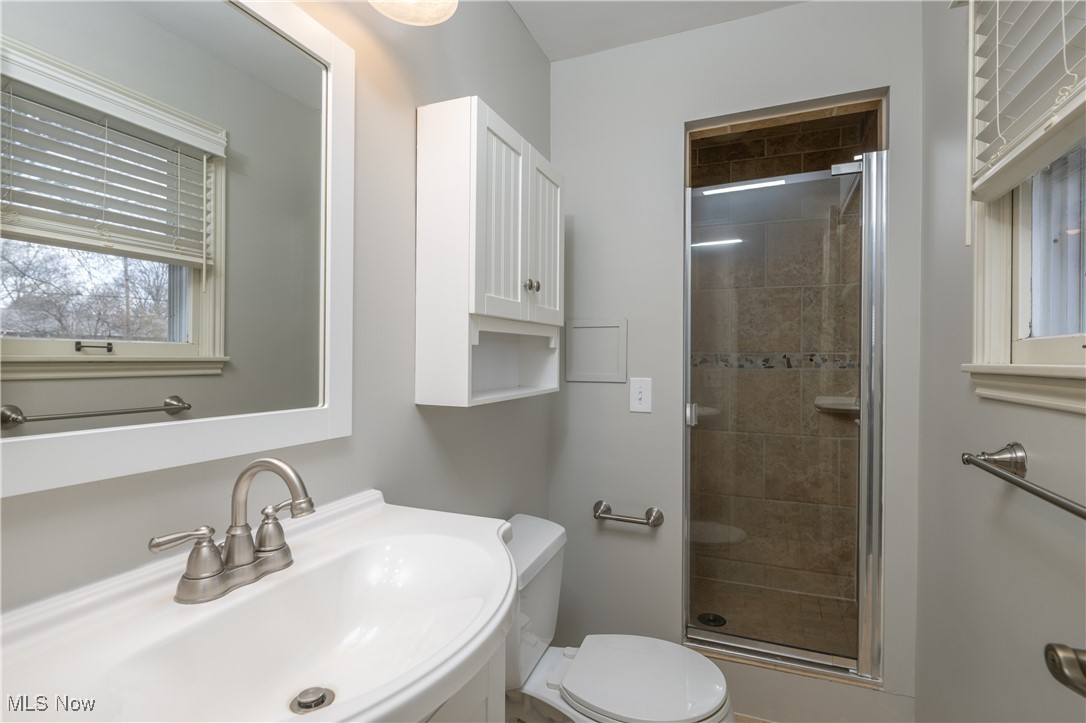 3721 20th Street Northwest Canton, OH 44708 - Photo 16 of 47 Bathroom with toilet, sink, and walk in shower
