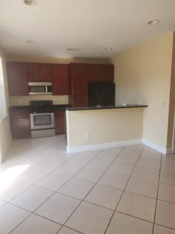 a kitchen with kitchen island cabinets and oven