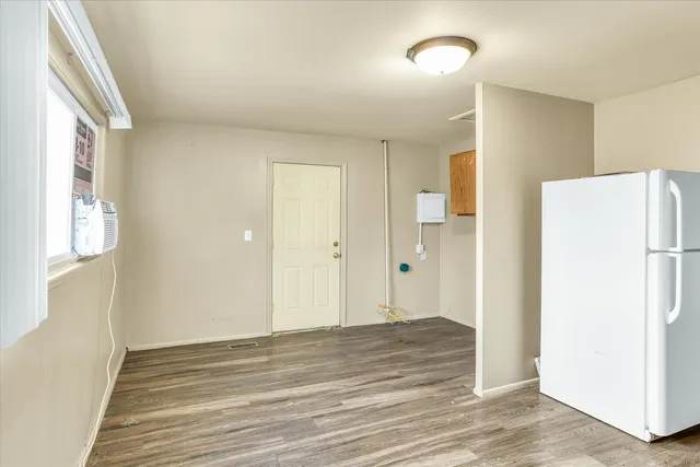 a view of a livingroom with wooden floor and closet