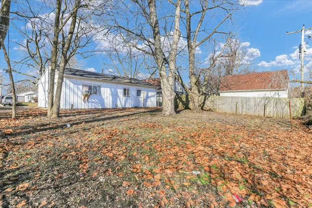 front view of a house with a large tree