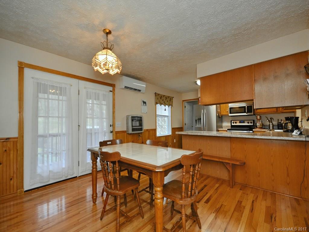 1010 Wesley Creek Road Clyde, NC 28721 - Photo 4 of 12 a view of a dining room with furniture window and wooden floor